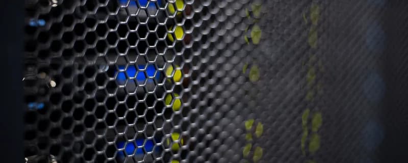 Blue and yellow status LEDs glowing through a tym2 server chassis mesh